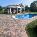 Cleaning and preparing stamped and dyed concrete for application of gloss color enhancing sealer.