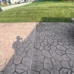 Cleaning and preparing stamped and dyed concrete for application of gloss color enhancing sealer.