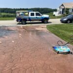 Cleaning and preparing stamped and dyed concrete for application of gloss color enhancing sealer.