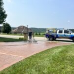 Cleaning and preparing stamped and dyed concrete for application of gloss color enhancing sealer.
